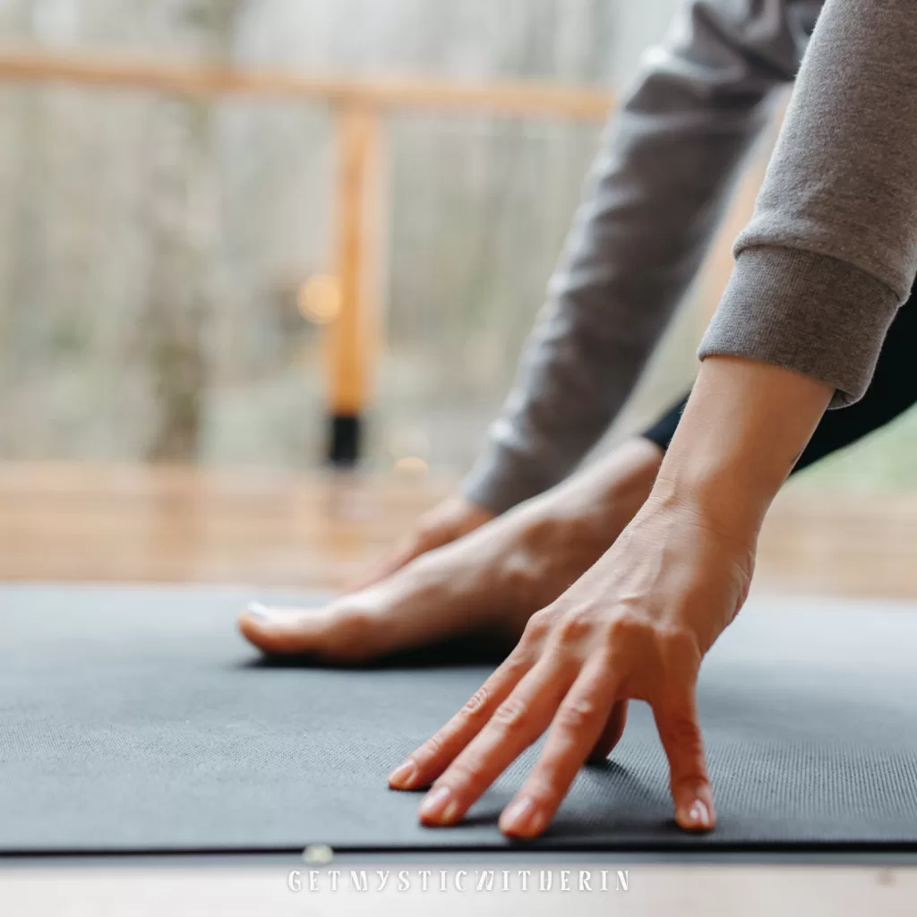 Close-up of a right foot and hands on a yoga mat in a low lunge. Gentle movement for autoimmune relief and improved mobility.